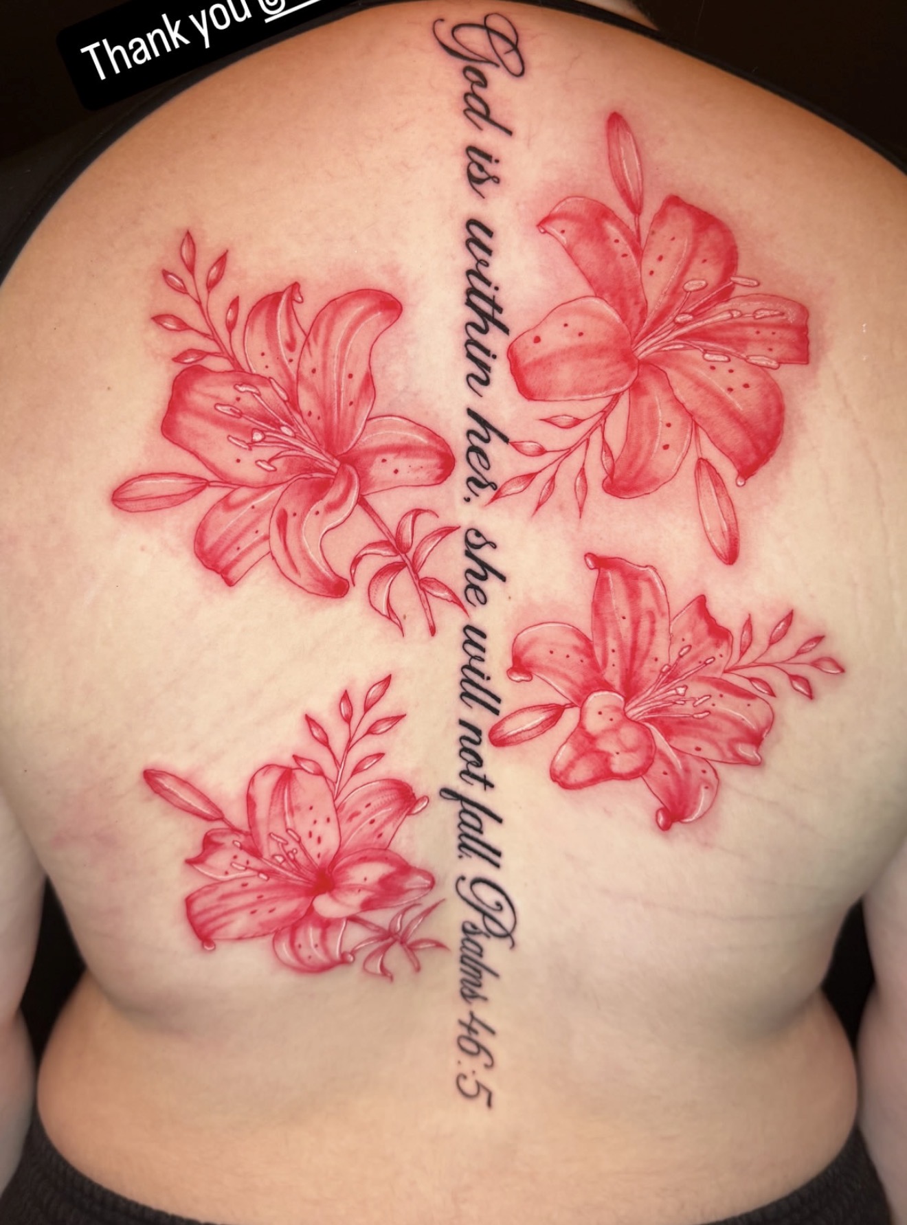 Red ink lily back piece with fine script lettering along the spine, by Peter Albert at Warpath Studio.
